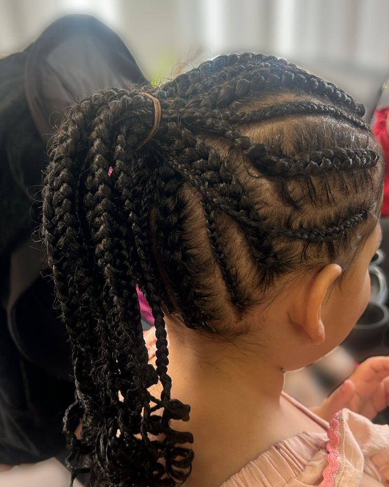 Child's curved cornrows gathered into a curly braided ponytail