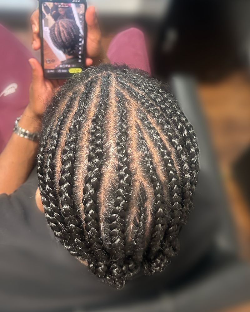 Men's straight-back cornrows in neat even rows, seen from above