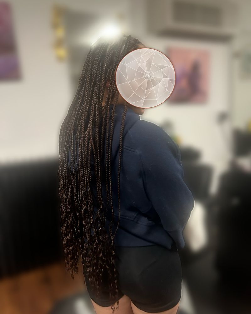 Waist-length boho knotless braids with loose curly strands