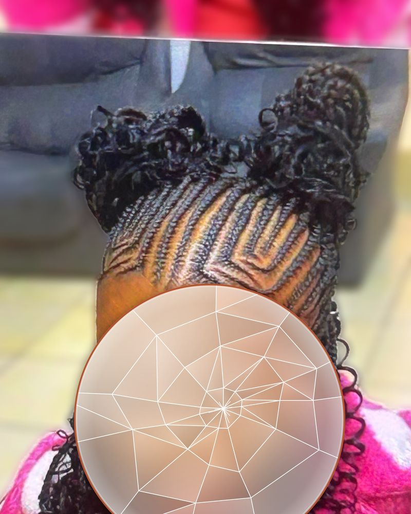 Child's cornrows swept up into two curly puffs