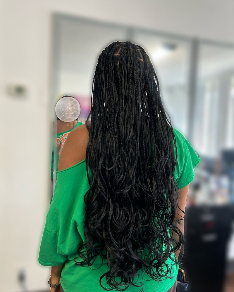 Waist-length boho knotless braids with curly ends
