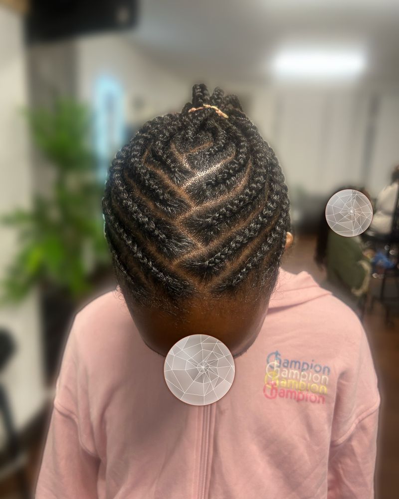 Child's zig-zag cornrows gathered into a high ponytail