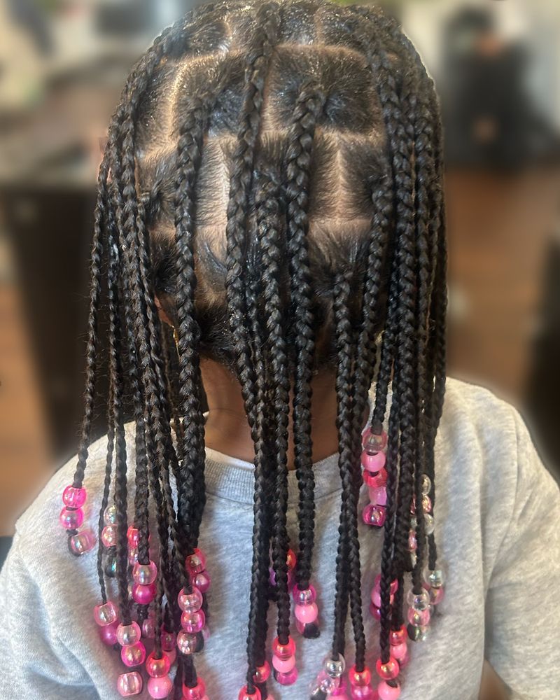 Child's knotless braids finished with pink and clear beads