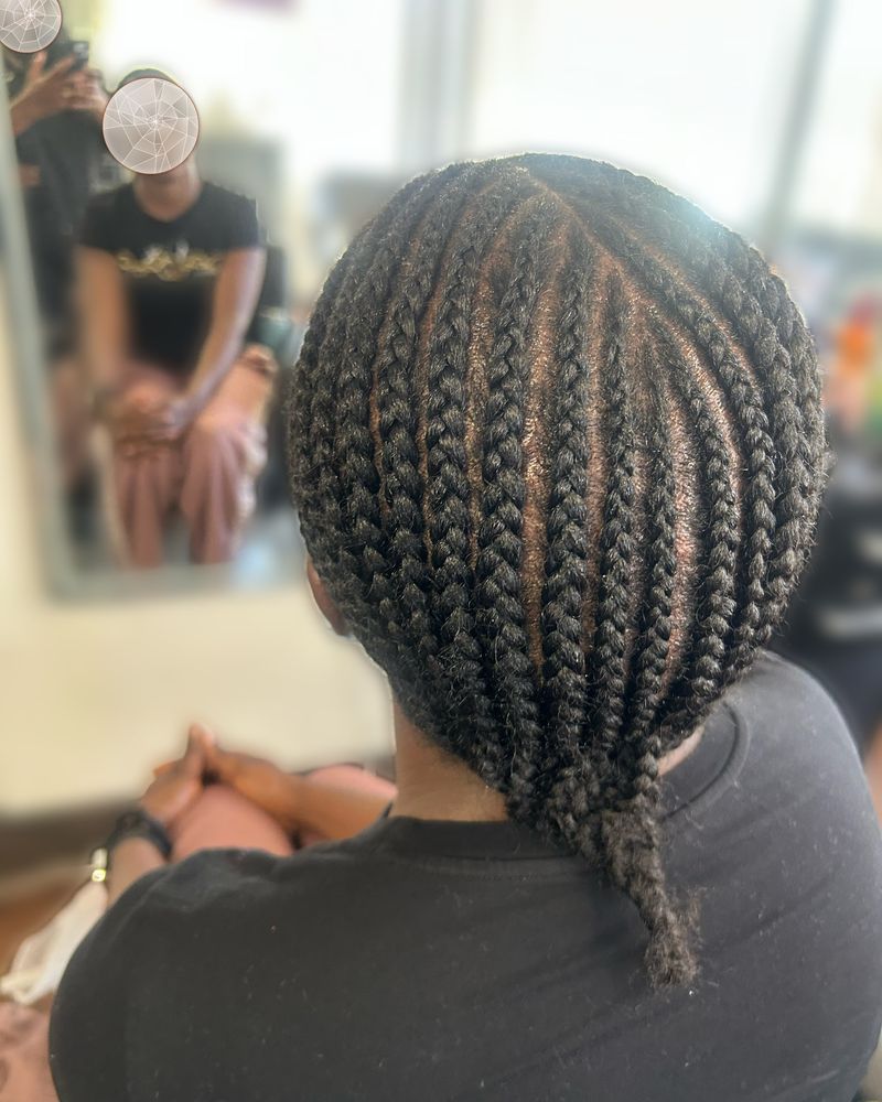 Straight-back cornrows gathered into a single braid