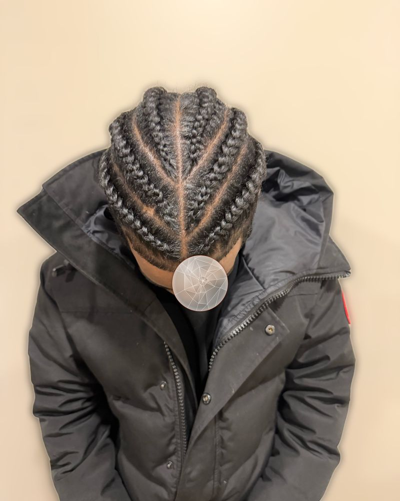 Men's straight-back cornrows with a center part, seen from above
