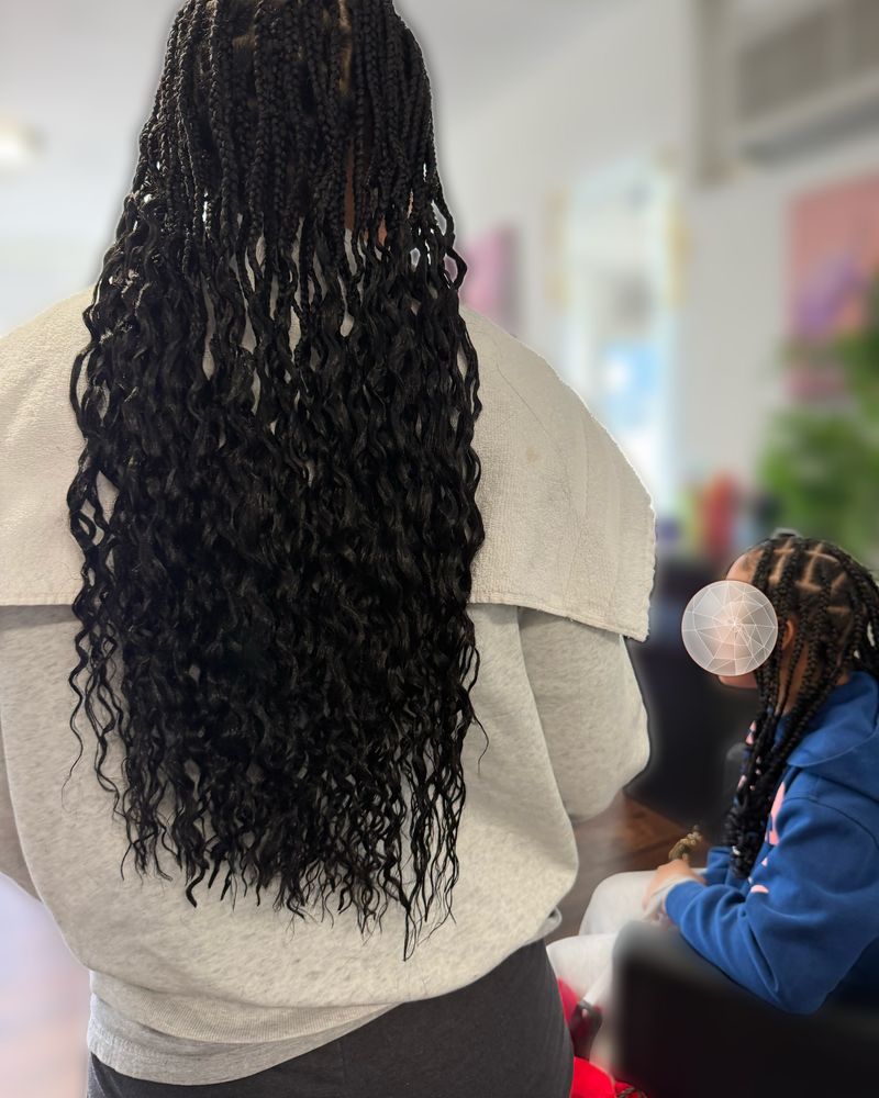 Waist-length boho knotless braids with curly ends