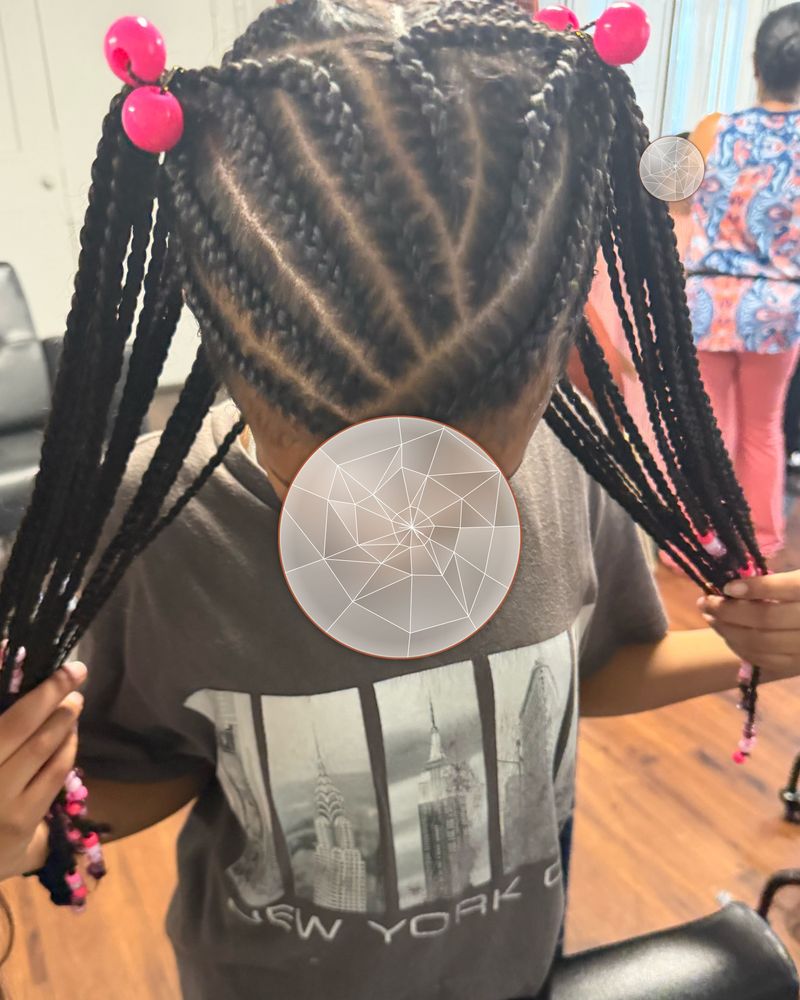 Child's cornrows gathered into two braided ponytails with pink bobbles