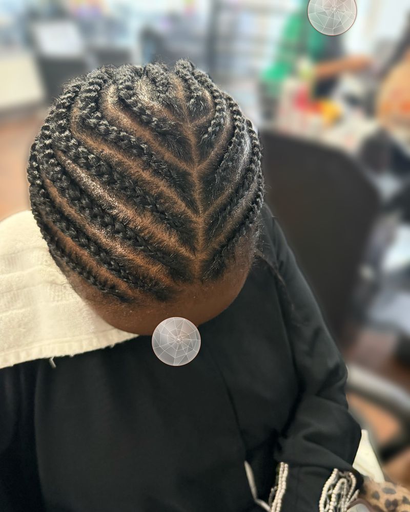 Men's curved cornrows sweeping from the side to the back