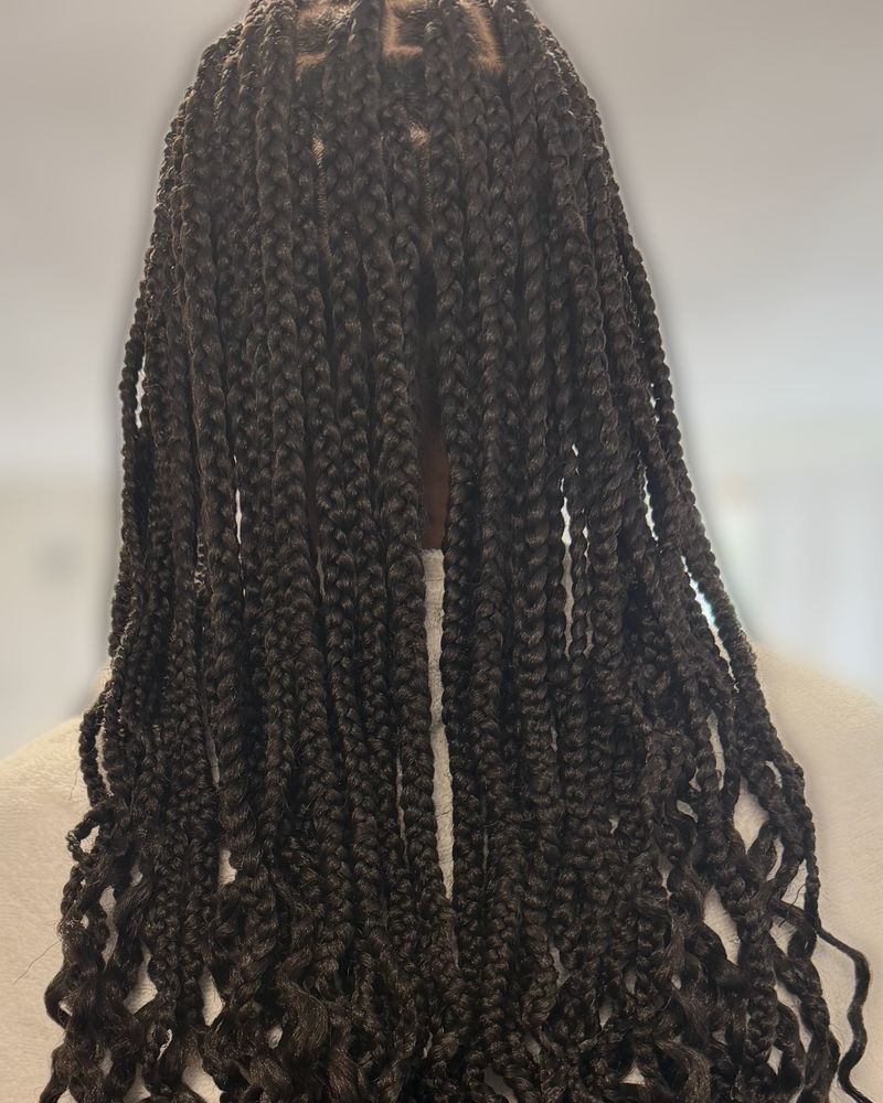 Long boho knotless braids with curly ends, seen from behind