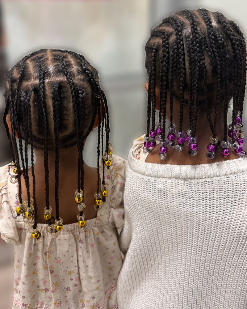 Two children's box-parted braids finished with yellow and purple beads